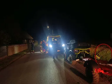 Nocna akcja służb ratunkowych i policji na wiejskiej drodze po zdarzeniu z udziałem quadów.