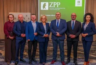 Siedmioro osób pozuje do grupowego zdjęcia podczas wydarzenia Związku Przedsiębiorców i Pracodawców w sali konferencyjnej.